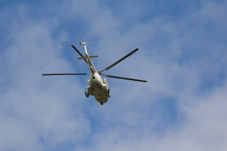 Helicopter flies against a blue sky background. Transportの写真素材
