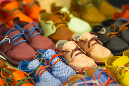 Vibrant kids shoes displayed on store shelves, showing a variety of playful designs and colors, ideal for illustrating children's fashion retail, playful footwear, and modern shopping experiences.の写真素材