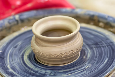 A pot on a potter's wheel, the shaping of a ceramic product.の写真素材