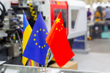 Flags of China European Union and Ukraine against the background of industrial equipmentの写真素材