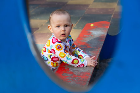 The baby plays on the playground in the park. Peopleの写真素材