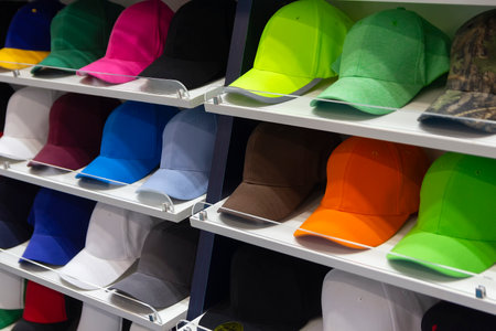 Colorful caps neatly displayed on shelves in an shop. Saleの写真素材