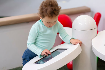 The child engages with an educational app in a play area.の写真素材