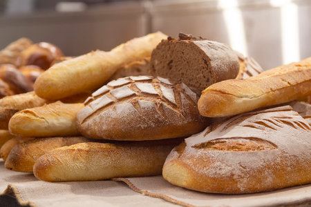Different kinds of fresh bread on the bakery counter. Foodの写真素材