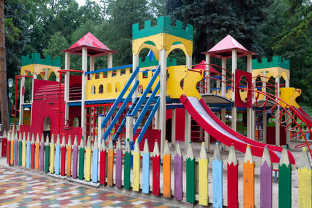 Colorful playground and guard in the form of pencils. Children's townの写真素材