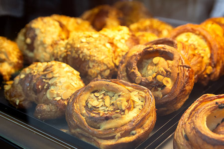Delicious pastries on a bakery window close-up. Foodの写真素材