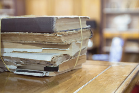 A bunch of old books on the table close-upの写真素材