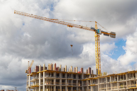 Construction crane on concrete high rise construction site. Industryの写真素材