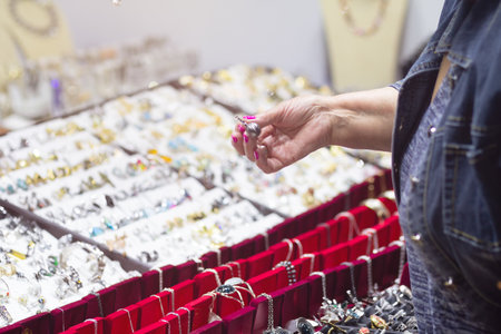 A woman chooses jewelry in a jewelry store. Saleの写真素材