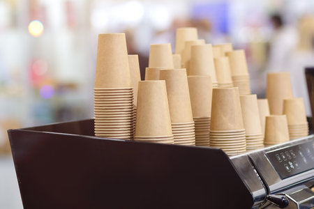 Lot of drinking paper coffee cups in piles. Stack of disposable coffee cupの写真素材