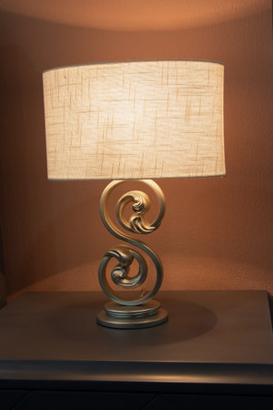 Elegant bedside lamp with a warm glow. Interiorの写真素材
