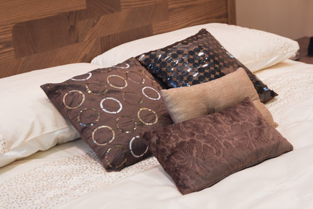 Beautiful pillows in a cozy bedroom. Interior