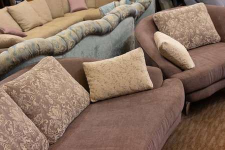 Convenient sofas with pillows in a furniture store. Saleの写真素材