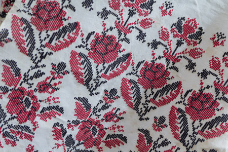 Red and white Ukrainian embroidery on white background close-up, texture of Ukrainian cross embroidery, flowers Ukrainian ornamentsの写真素材