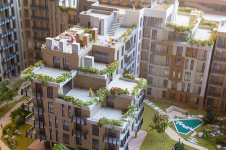 Building a model of modern housing with gardens light burning on the table. Architectureの写真素材