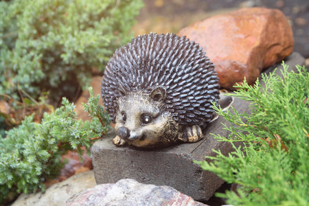 A small garden sculpture of a hedgehog. Decorationの写真素材
