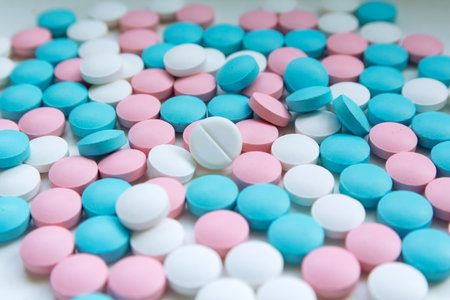 White, blue and pink tablets scattering on the table. Backgroundの写真素材
