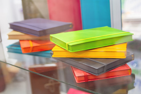 Multicolored notebooks on the showcase of the stationery store. Saleの写真素材