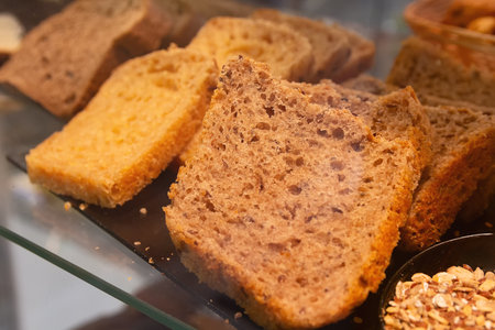 A slice of hearty, sweet bread in the window of a bakery. Food
