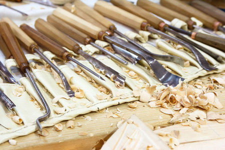 Wood shavings and chisels for carpentry on the table. Woodworking