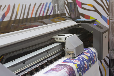 Large format printing machine in the printing house. Industry