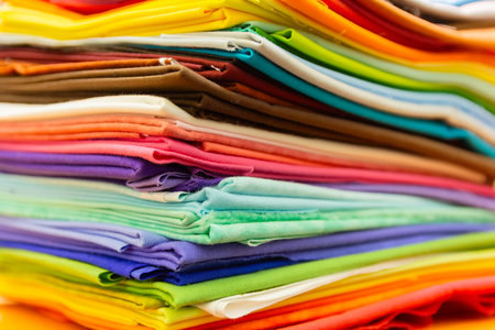Stack of colorful folded fabrics close-upの写真素材