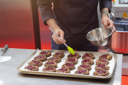 Confectioner makes delicious cookies on a pastry shop tray. Food industryの写真素材