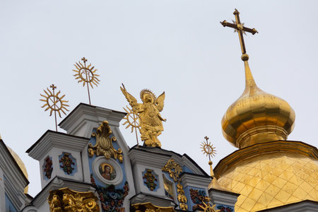 Golden angel and domes of Mikhailovsky Golden-dominated monastery in Kyiv. Ukraineの写真素材