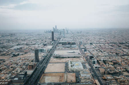 Skyline view at Riyadh in direction of King Abdullah Financial District from the top of Riyadh Kingdom tower in foggy cloudy dayのeditorial素材
