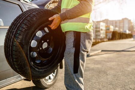 Close-up of a car tire. The driver should replace the old wheel with a spareの写真素材