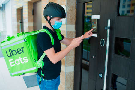 Kyiv, Ukraine - May 06, 2020: The Uber Eats courier. Food delivery concept. Food delivery man...
