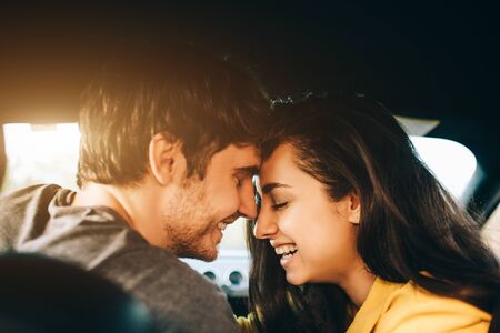 tourism - Happy young Man and woman Happy sit in a car. Travel and adventure concept.の写真素材