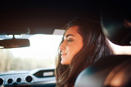 Travel, tourism -Beautiful woman with a couple of tea or coffee smiling while sitting on the seat in the carの写真素材
