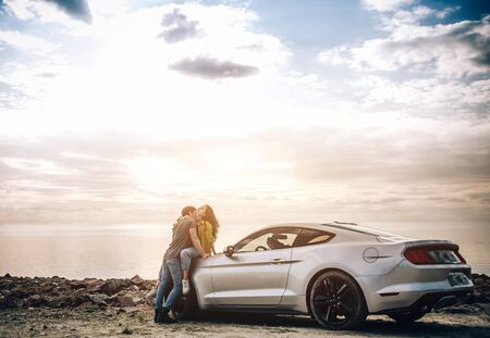 Romantic young couple sharing a special moment while outdoors. Young couple in love on a road trip....