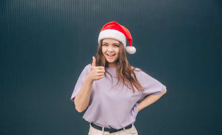 Young stylish trendy woman isolated over grey blue background. Cheerful positive girl in red festive...