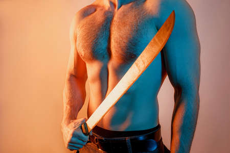 Cropped image of man with sharp machete in handの写真素材