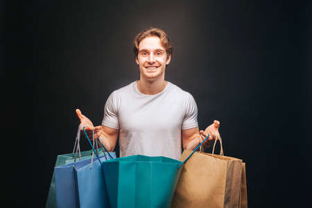 Man hold one opened and other clothes shop bagsの写真素材