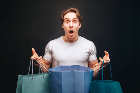 Man hold one opened and other clothes shop bagsの写真素材
