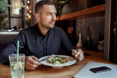 Young businessman is having lunch in restaurantの写真素材