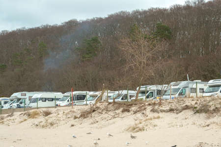 auto camping.Camping car for relaxing with family on the background of sea sunset, theme of relaxation and natureの写真素材