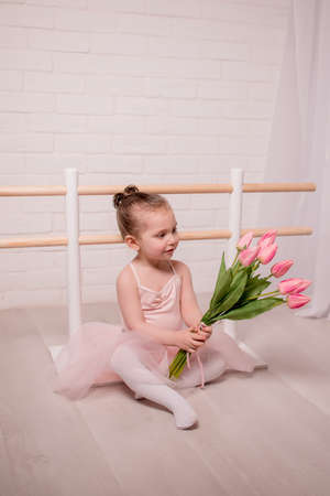 Ballet teacher and little ballerina have practice in dance class. little beautiful girl is doing ballet..の写真素材
