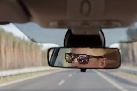 Generic photo of man driving a car through slight turn. man drivingの写真素材