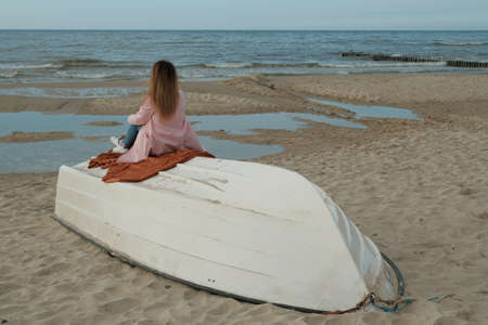 girl on a boat watching the sunset.の写真素材
