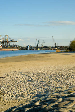 industrial area on the coast. big cranes in the background. port..