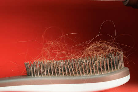 the concept of hair loss in women. comb with hair close-up.