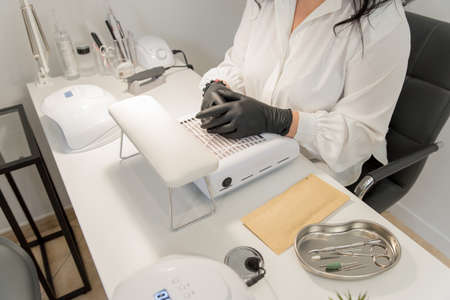 nail salon. workplace of a manicurist. manicurist paints nails to a client.の写真素材