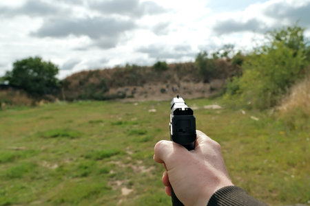 the hand is holding a firearm. pistol. training at the shooting range