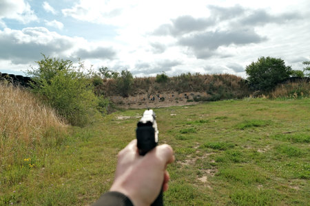 the hand is holding a firearm. pistol. training at the shooting range
