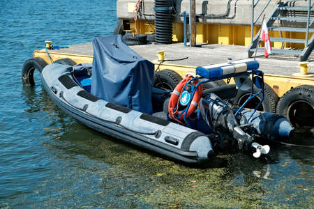 coast police boat. a police motorboat is moored to the pier.