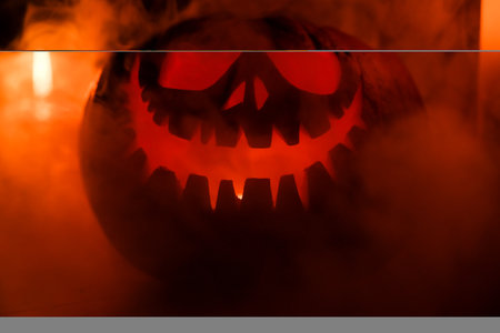 Halloween's holiday attributes. Halloween. carved pumpkin. candles . smoke . dark scene. pumpkin...